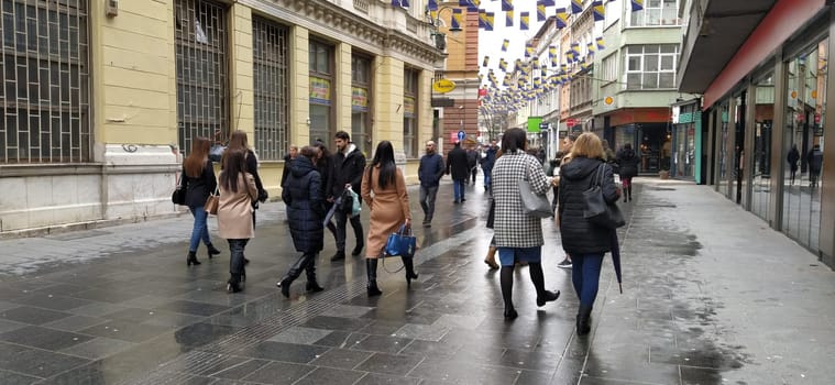 Sarajevo, Bosnia and Herzegovina, March 8, 2020. People on the streets of Sarajevo. Tourists and locals walk around the city center, visit shops, cafes. Historic Center of Sarajevo with Attractions.