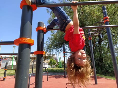 Sremska Mitrovica, Serbia. June 6, 2020. Flip-flops, weight lifting and weights, strength exercises. Two teenagers go in for sports on simulators, children on a sports ground.