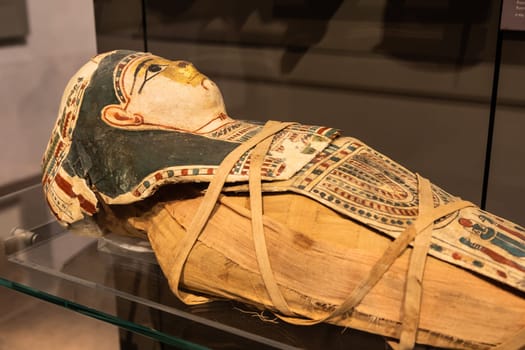 Turin, Italy - March 2023: Egyptian Museum, mummy of a baby with a mask - 2nd Century BC
