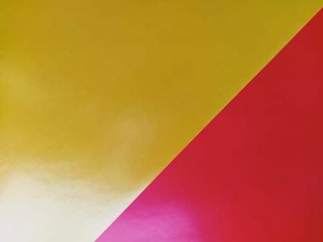 Yellow-pink bright background. Diagonally laid sheets of colored paper with a gradient and light flare.