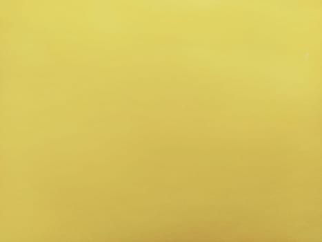 Nice yellow background. A sheet of paper close-up. Pure cheerful color. Vivid shade of yellow.