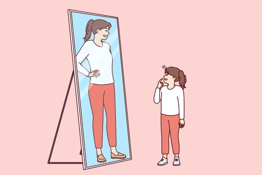 Little girl stands and looks in mirror, saw reflection of adult woman and dreams of becoming adult as soon as possible. Preteen girl wants to be as beautiful as mother or older sister