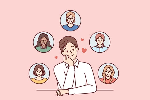 Young monogamous man thinks about girls while choosing which fan to invite on romantic date. Monogamous guy loves several women at same time and introduces them while sitting at table