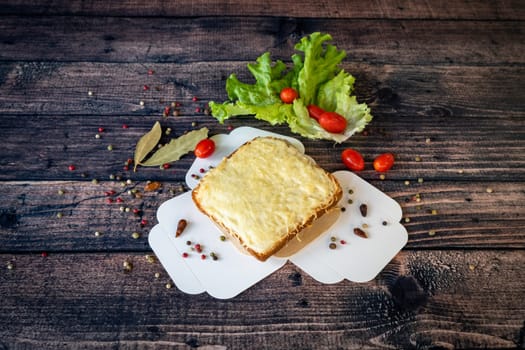 grilled croque monsieur with melted cheese served on a wooden base
