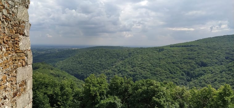Ruins of an old fortress in Vrdnik, Sremska Mitrovica, Vojvodina, Serbia. Ancient stone walls with mountain ranges in the background. Tourist historical sights. Edge of the wall.
