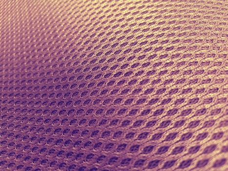 Pink synthetic porous material with a gradient in purple and yellow. Close-up tilted. Polyester fabric. Fabric for sewing clothes, upholstery and furniture