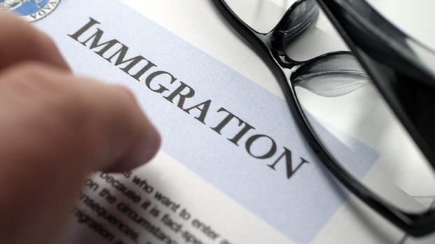 Finger tapping on immigration document