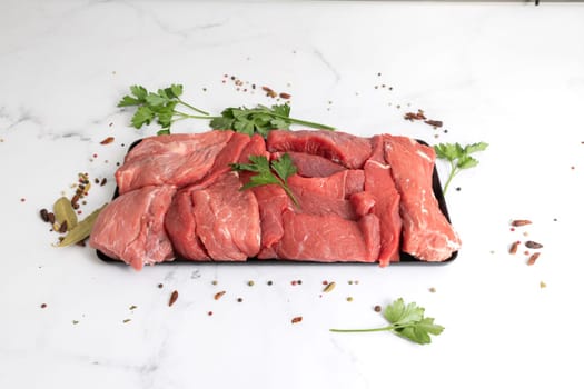 Fresh and tasted meat on a plate with herbs