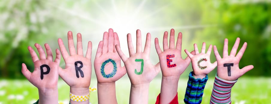 Children Hands Building Colorful English Word Project. Summer, Sunny Green Grass Meadow As Background
