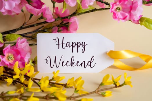 Spring Flower Arrangement With White Label With English Text Happy Weekend. Colorful Flower Branch Decoration With Yellow And Purple Blossoms.