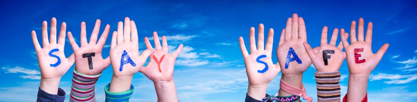 Children Hands Building Colorful English Word Stay Safe. Blue Sky As Background