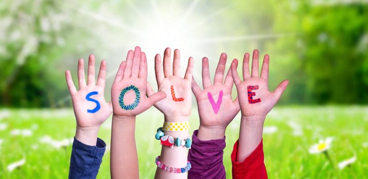 Children Hands Building Colorful English Word Solve. Summer, Sunny Green Grass Meadow As Background
