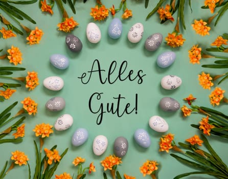 Flat Lay With German Text Alles Gute Means Best Wishes. Easter Egg Decoration With Orange Spring Flowers. Light Green Paper Background.