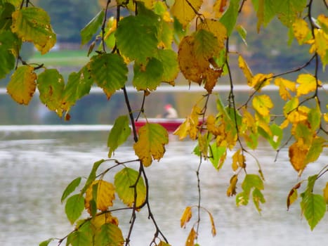 A person floats by on a canoe on Lake Colby in Lake Saranac New York.