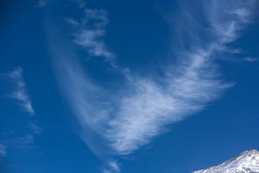 Wind swept clouds over mountains.