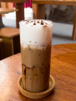 Iced matcha greentea on wooden table in coffee shop, stock photo