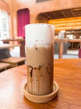 Iced matcha greentea on wooden table in coffee shop, stock photo
