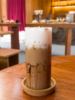 Iced matcha greentea on wooden table in coffee shop, stock photo