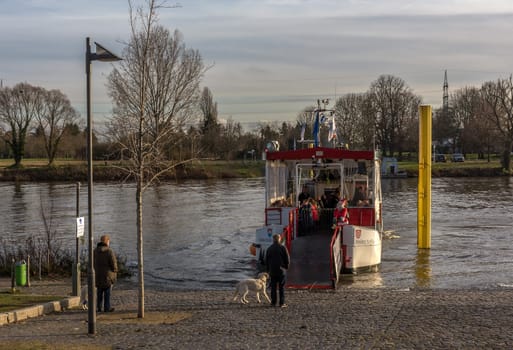 Unidentified people are waiting for the Main ferry in Frankfurt Höchst, Germany