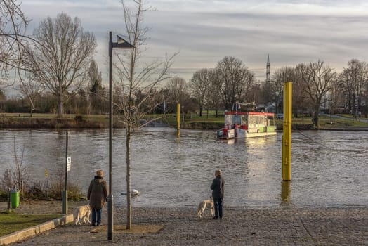 Unidentified people are waiting for the Main ferry in Frankfurt Höchst, Germany