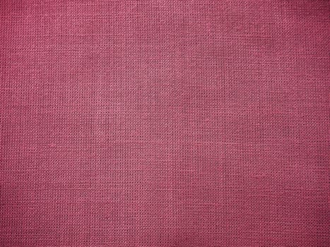Cloth close-up. Interlacing of threads. A piece of pink fabric. Fabric background. Copy space.
