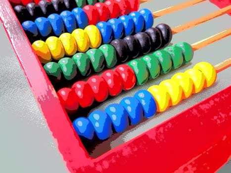 Education concept - abacus with many colorful beads. Red, blue, green, black, yellow details on the abacus. Mathematical exercises. School program.