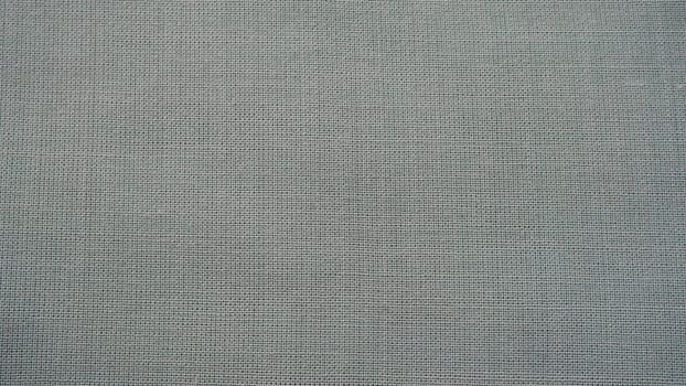 Texture canvas fabric as background. Gray sackcloth. Grey linen scrim.