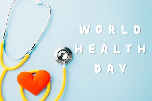 World Health Day. Yellow doctor stethoscope and world globe with Red heart shape isolated on blue background with copy space, Save world day, Healthcare life Insurance, Health care and medical concept