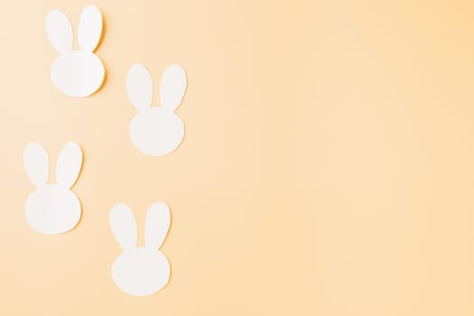 Easter Day Concept. Above overhead handmade white paper rabbit cutting isolated on pastel background with copy space for your text, Happy Easter Bunny holiday, Banner design for web