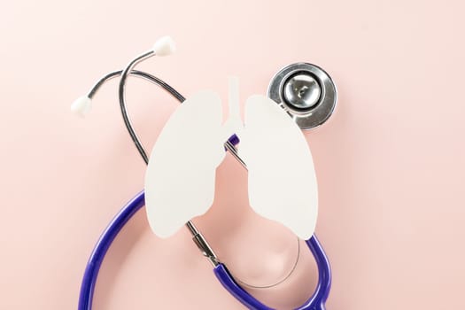 World tuberculosis day. Lungs paper cut symbol and medical stethoscope on pastel pink background, copy space, concept of world TB day, banner background, respiratory diseases, lung cancer awareness