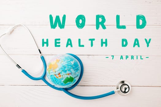 World Health Day. Top view doctor stethoscope wrapped around world globe isolated on wooden background with copy space for text, Save world day, Health care and medical concept