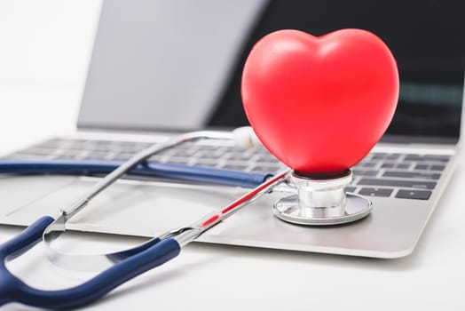 Doctor Day Concept, Health doctor stethoscope and red heart on keyboard of laptop computer with copy space, care patient in hospital, Medical and Healthcare insurance, RX prescription
