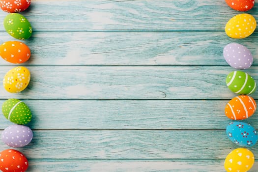 Happy Easter Day Concept. Top view holiday banner background web design white colorful easter eggs painted on blue wood background with empty copy space, celebration greeting card, overhead, template