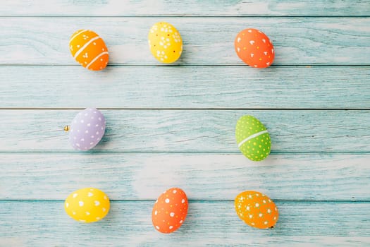 Happy Easter Day Concept. Top view holiday banner background web design white colorful easter eggs painted on blue wood background with empty copy space, celebration greeting card, overhead, template