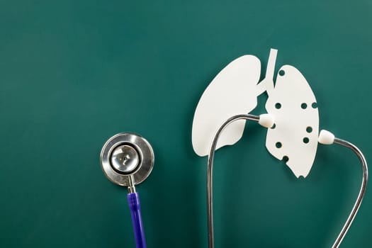 World tuberculosis day. Lungs paper cutting symbol and medical stethoscope on green background, copy space, concept of world TB day, banner background, respiratory diseases, lung cancer awareness