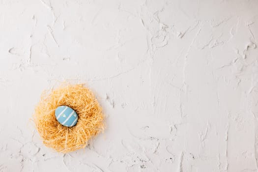 Top view holiday banner background web design white easter eggs in brown nest on white cement background with empty copy space, celebration greeting card, overhead, template, Happy Easter Day Concept