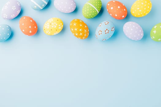 Colorful easter eggs isolated on blue background with copy space, Funny decoration, Creative composition banner web design holiday background, Happy Easter Day greeting card, flat lay top view