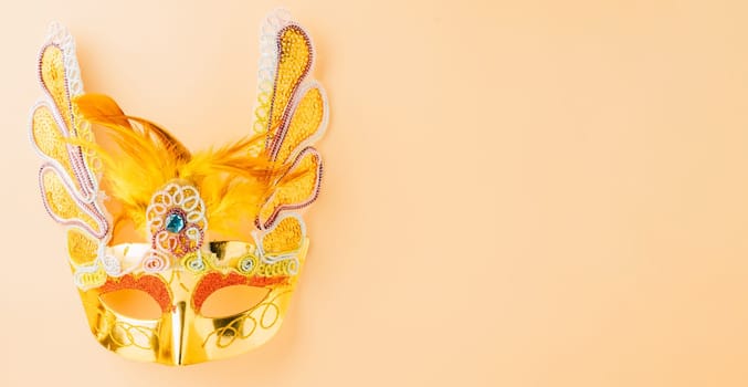 Happy Purim carnival decoration. Jewish Purim and Mardi Gras in Hebrew, celebration holiday background banner design, Golden venetian ball mask, carnival mask isolated on pastel background