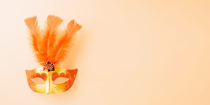 Happy Purim carnival decoration. Top view venetian ball mask with red feather on pastel background with copy space, Masquerade party, Jewish Purim in Hebrew, holiday background banner design
