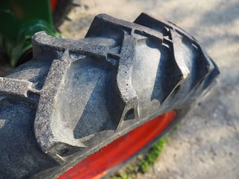 tire from a motor-cultivator. A close-up of a wheel from a small farm tractor. Rubber thread. Industrial details