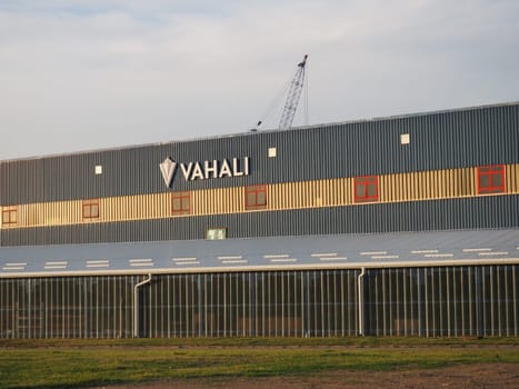 Zasavica, Machvanska Mitrovica, Serbia April 30, 2021. VAHALI shipyard and ship repair yard. Industrial building. View from the street at the golden hour. Due to VAHALI crane.