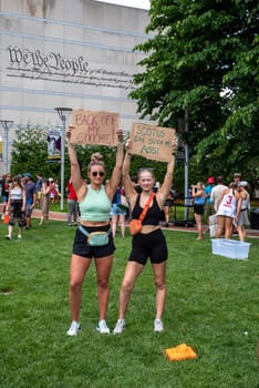 Philadelphia, PA USA 06-25-2002 Two young women hold up feminist protest signs at pro-choice political rally with a crowd gathering behind them. Josh Shapiro rally. Editorial use only.