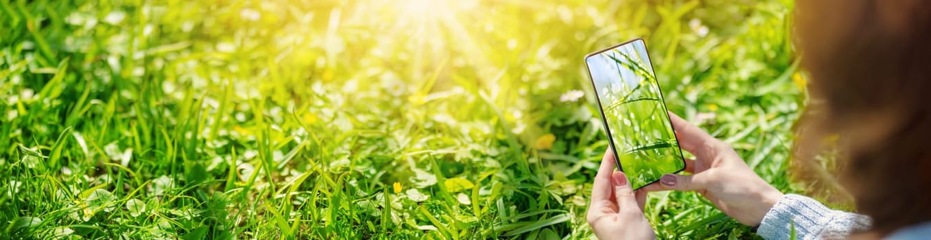 Woman making photos of the nature in sunny day. Concept of the photographing and vacation.