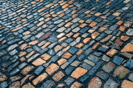The pavement of granite stone. Paved roadway street, texture, background, selective focus.