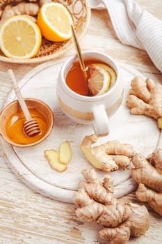 Ginger tea with lemon and honey on a wooden table