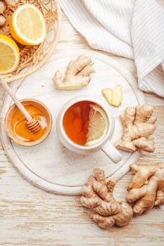 Ginger tea with lemon and honey on a wooden table
