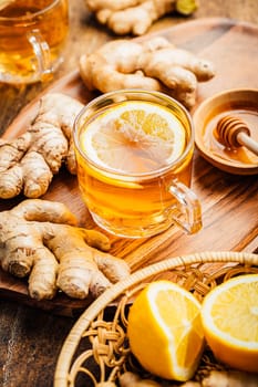 Ginger tea with lemon and honey on a wooden table