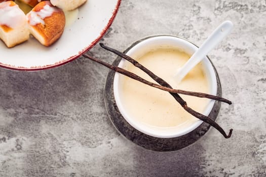 Buchteln, sweet rolls made of yeast dough with milk and butter, served with vanilla sauce. Traditional meatless dish in Europe