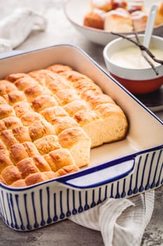 Buchteln, sweet rolls made of yeast dough with milk and butter, served with vanilla sauce. Traditional meatless dish in Europe