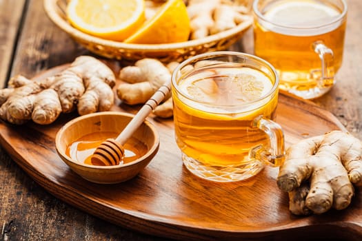 Ginger tea with lemon and honey on a wooden table